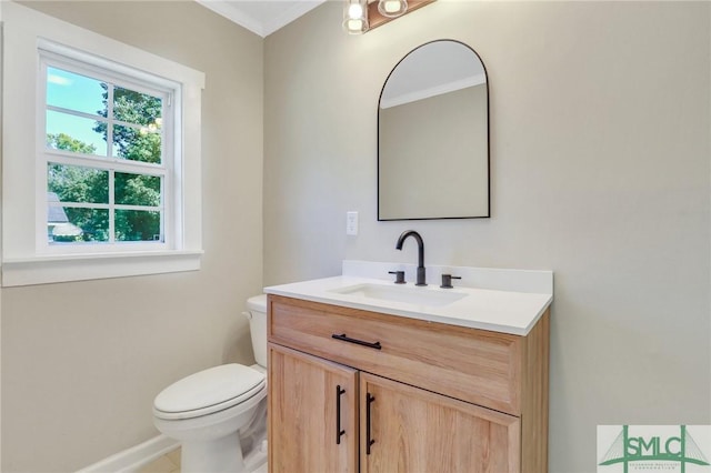 bathroom with vanity, ornamental molding, and toilet