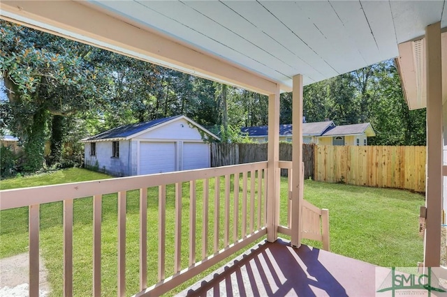 exterior space with a garage, an outbuilding, and a yard