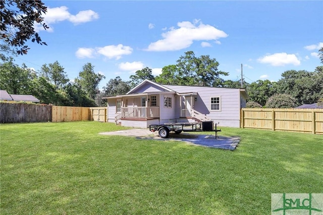 rear view of house with a yard and covered porch