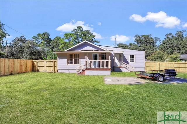 rear view of property with a yard