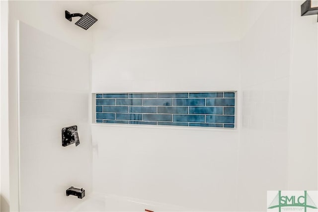 interior details featuring washtub / shower combination