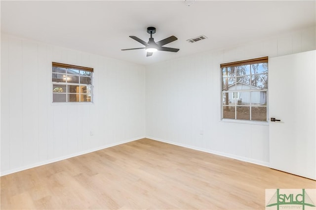 unfurnished room with ceiling fan and light wood-type flooring