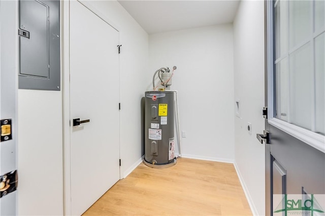 utility room featuring electric water heater and electric panel