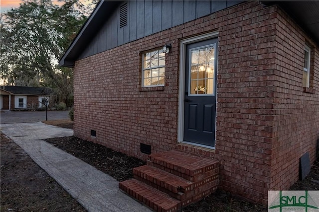 view of exterior entry at dusk