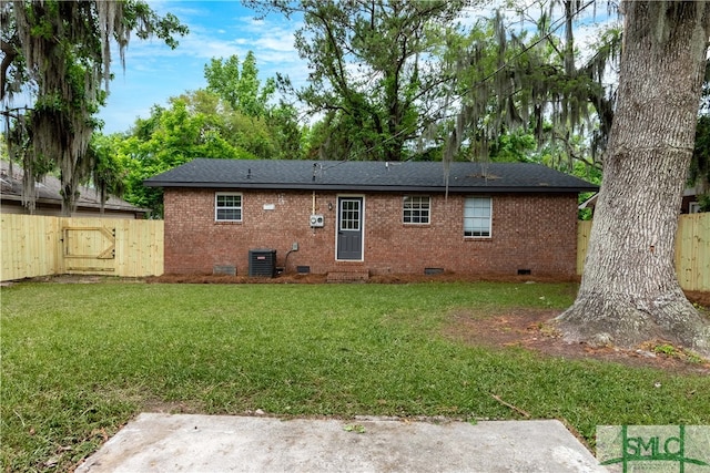 rear view of property featuring crawl space, brick siding, a gate, and a shingled roof