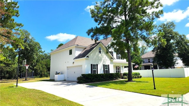 view of front of property with a garage and a front lawn