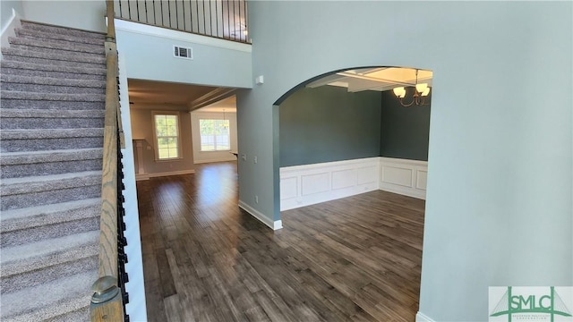 foyer with dark hardwood / wood-style floors and an inviting chandelier