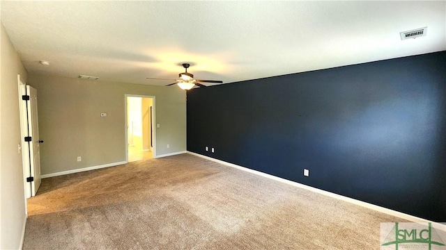 spare room featuring carpet flooring and ceiling fan