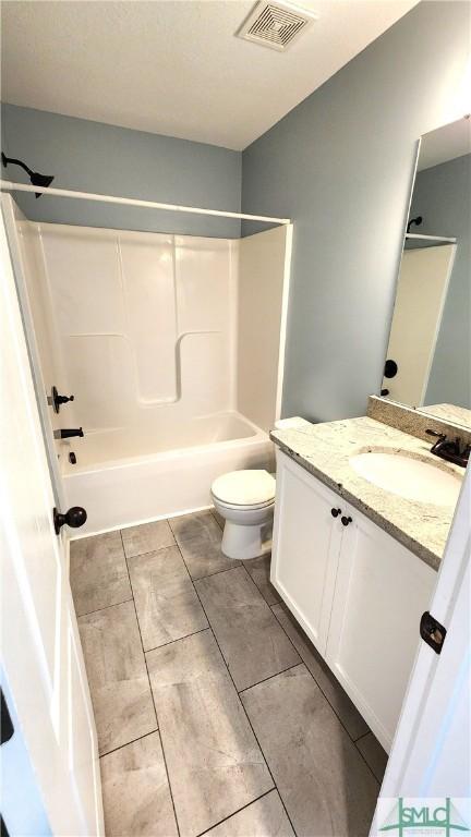 full bathroom featuring vanity, toilet, and shower / bath combination