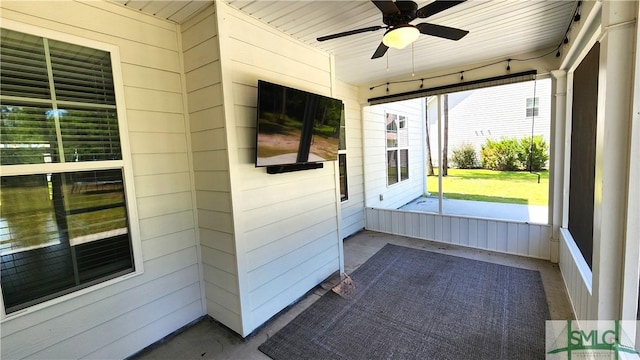 unfurnished sunroom featuring ceiling fan