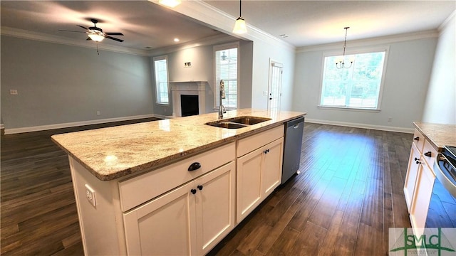 kitchen featuring sink, hanging light fixtures, stainless steel dishwasher, an island with sink, and white cabinetry