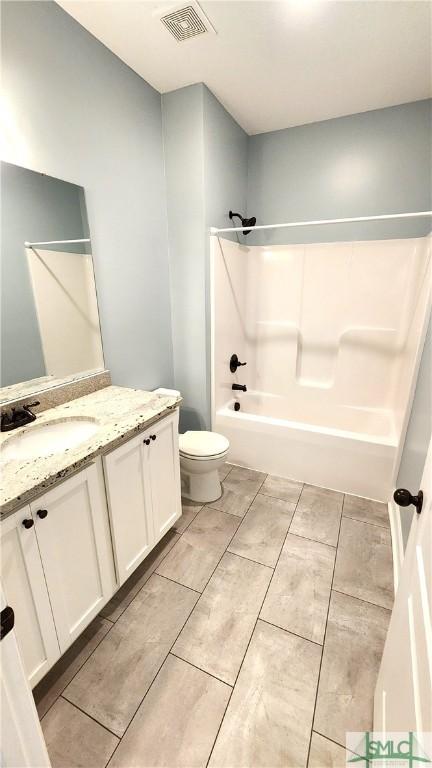 full bathroom with shower / bathing tub combination, vanity, and toilet