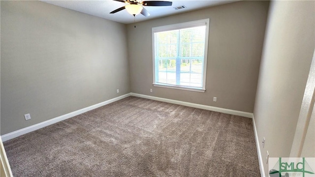 carpeted spare room featuring ceiling fan