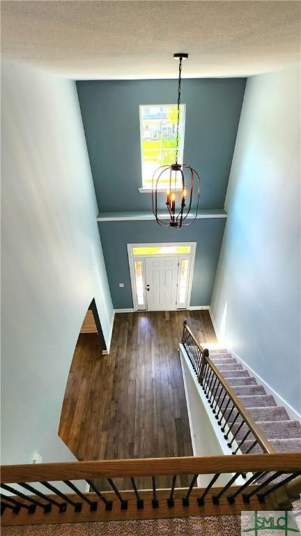 interior space featuring a chandelier and dark wood-type flooring