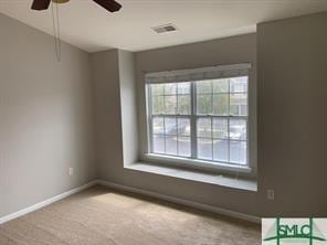 unfurnished room featuring carpet and ceiling fan