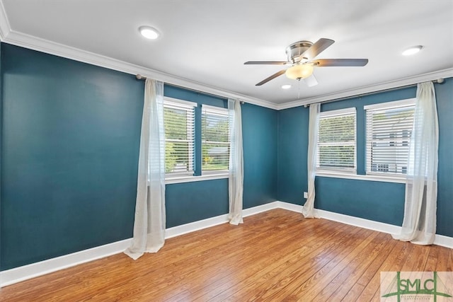 unfurnished room with hardwood / wood-style floors, crown molding, ceiling fan, and a healthy amount of sunlight