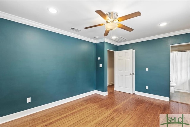 spare room with ceiling fan, wood-type flooring, and crown molding