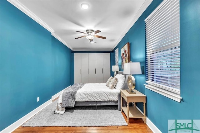 bedroom featuring wood-type flooring, ceiling fan, and ornamental molding