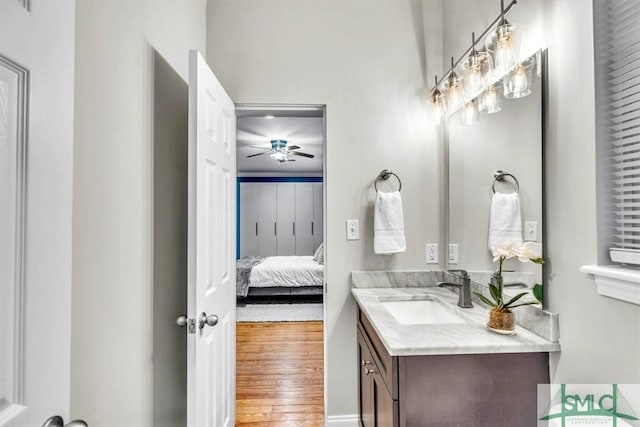 bathroom with hardwood / wood-style flooring, vanity, and ceiling fan