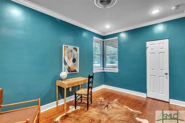 home office with crown molding and wood-type flooring