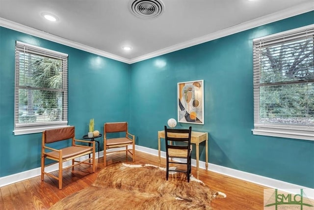 sitting room featuring hardwood / wood-style floors and crown molding