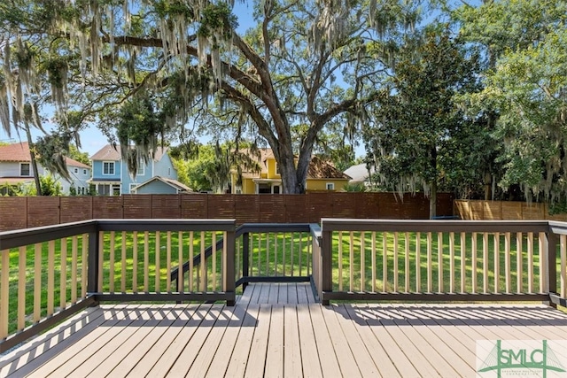 wooden terrace featuring a yard