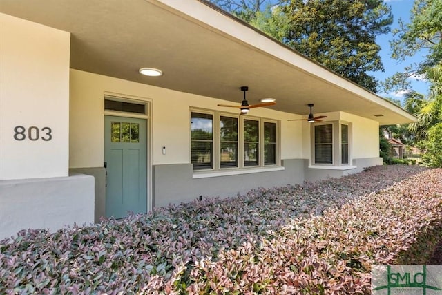 doorway to property with ceiling fan