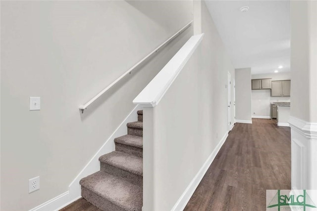 stairway with hardwood / wood-style floors