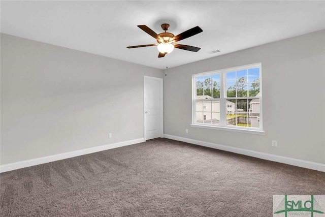 carpeted spare room featuring ceiling fan