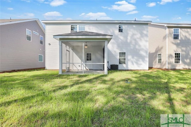 back of house with a lawn, a sunroom, ceiling fan, cooling unit, and a patio