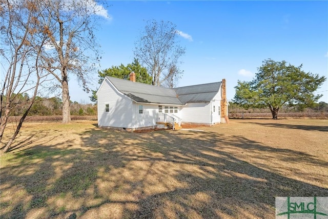 rear view of property with a yard