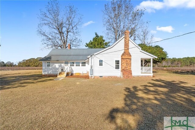 back of house with a lawn