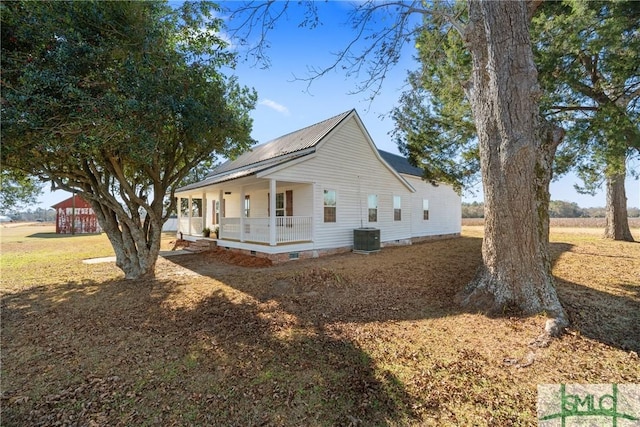 view of side of home with a porch and cooling unit