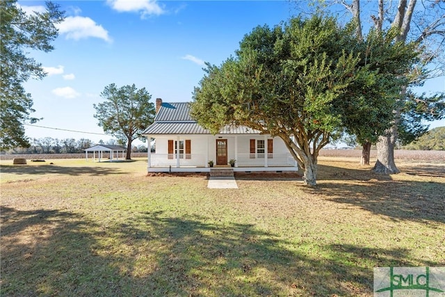 view of front of property featuring a gazebo, covered porch, and a front yard