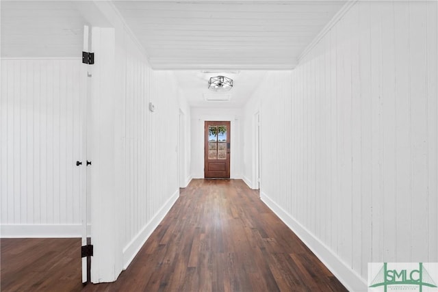 hall with dark wood-type flooring and ornamental molding