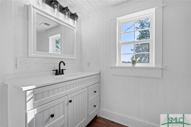 bathroom featuring wood walls, vanity, and hardwood / wood-style flooring