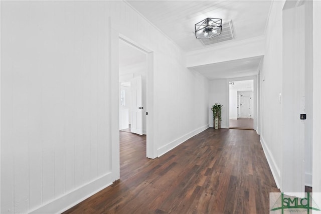 hall with crown molding and dark wood-type flooring