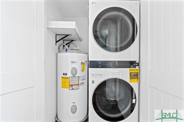 laundry area with electric water heater and stacked washer and dryer