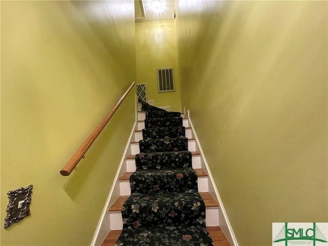 stairs with wood-type flooring