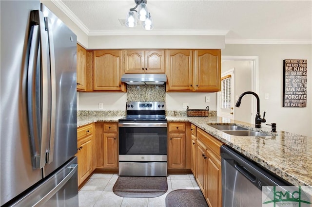 kitchen featuring light stone countertops, appliances with stainless steel finishes, ornamental molding, and sink