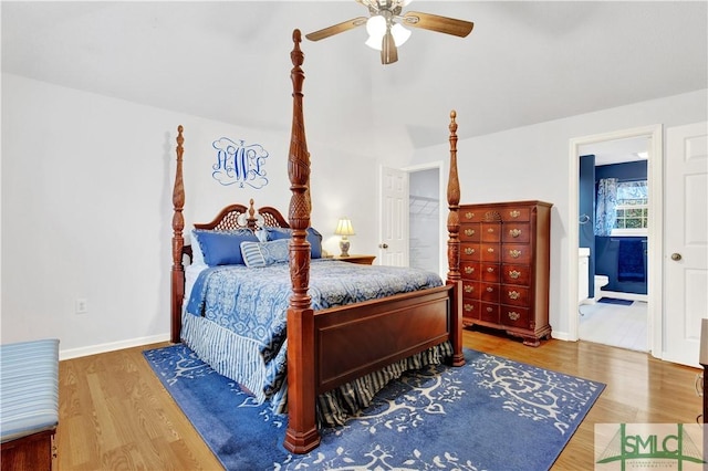 bedroom featuring ceiling fan, wood-type flooring, and ensuite bath