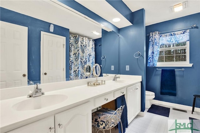 bathroom featuring tile patterned floors, vanity, and toilet