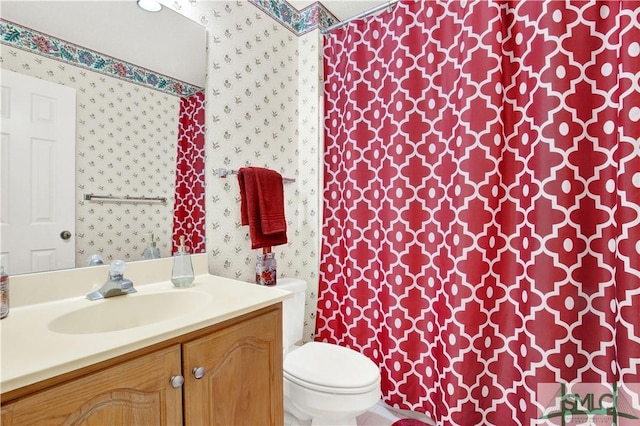 bathroom featuring vanity and toilet