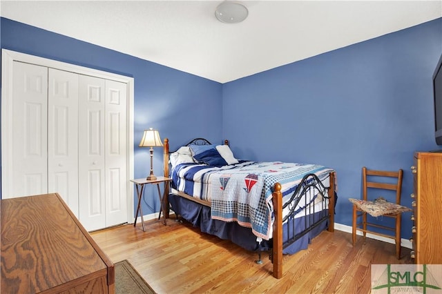 bedroom featuring hardwood / wood-style floors and a closet