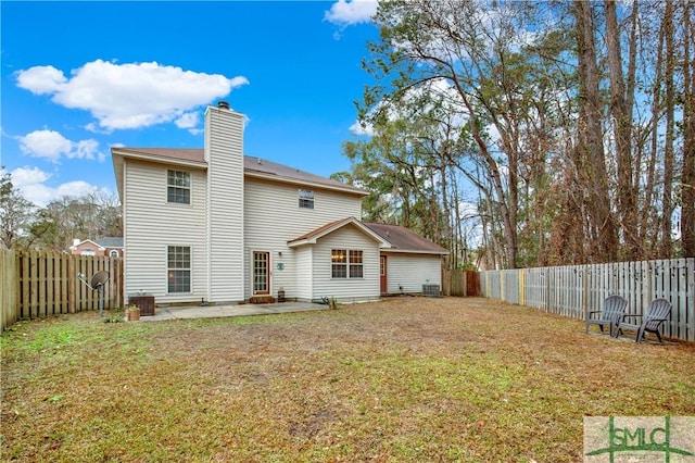 rear view of property featuring a lawn and a patio