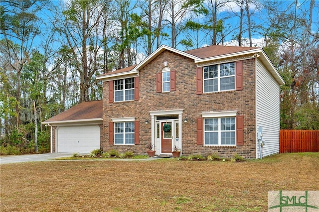 colonial inspired home with a garage and a front yard