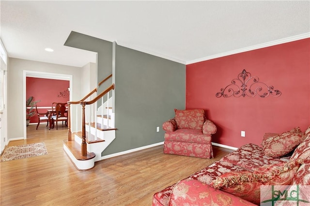 living room featuring wood-type flooring and crown molding