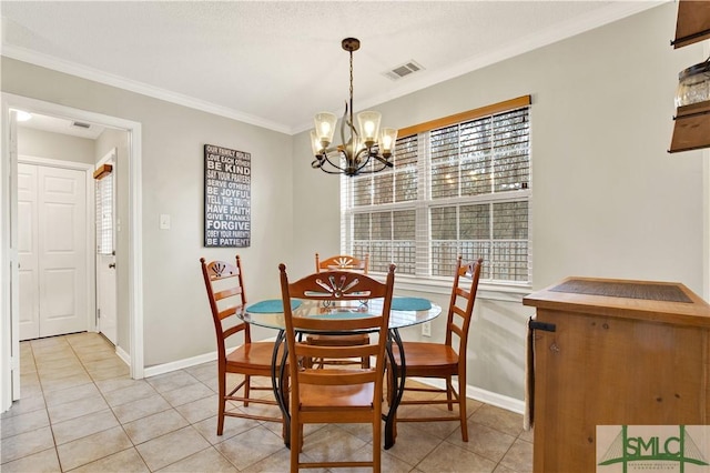 tiled dining space featuring an inviting chandelier and ornamental molding