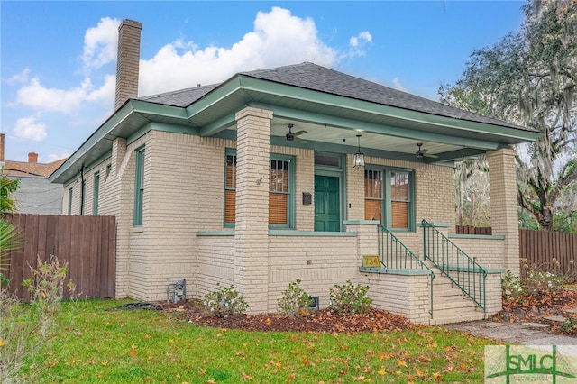 view of front of home with ceiling fan, a porch, and a front lawn