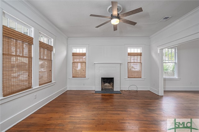 unfurnished living room with ceiling fan, dark hardwood / wood-style floors, crown molding, and a fireplace